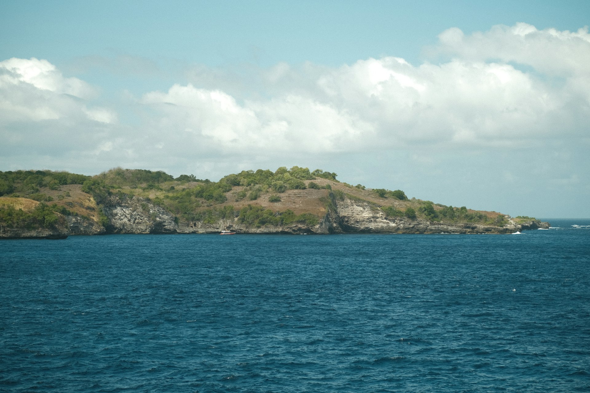A small island in the middle of a body of water